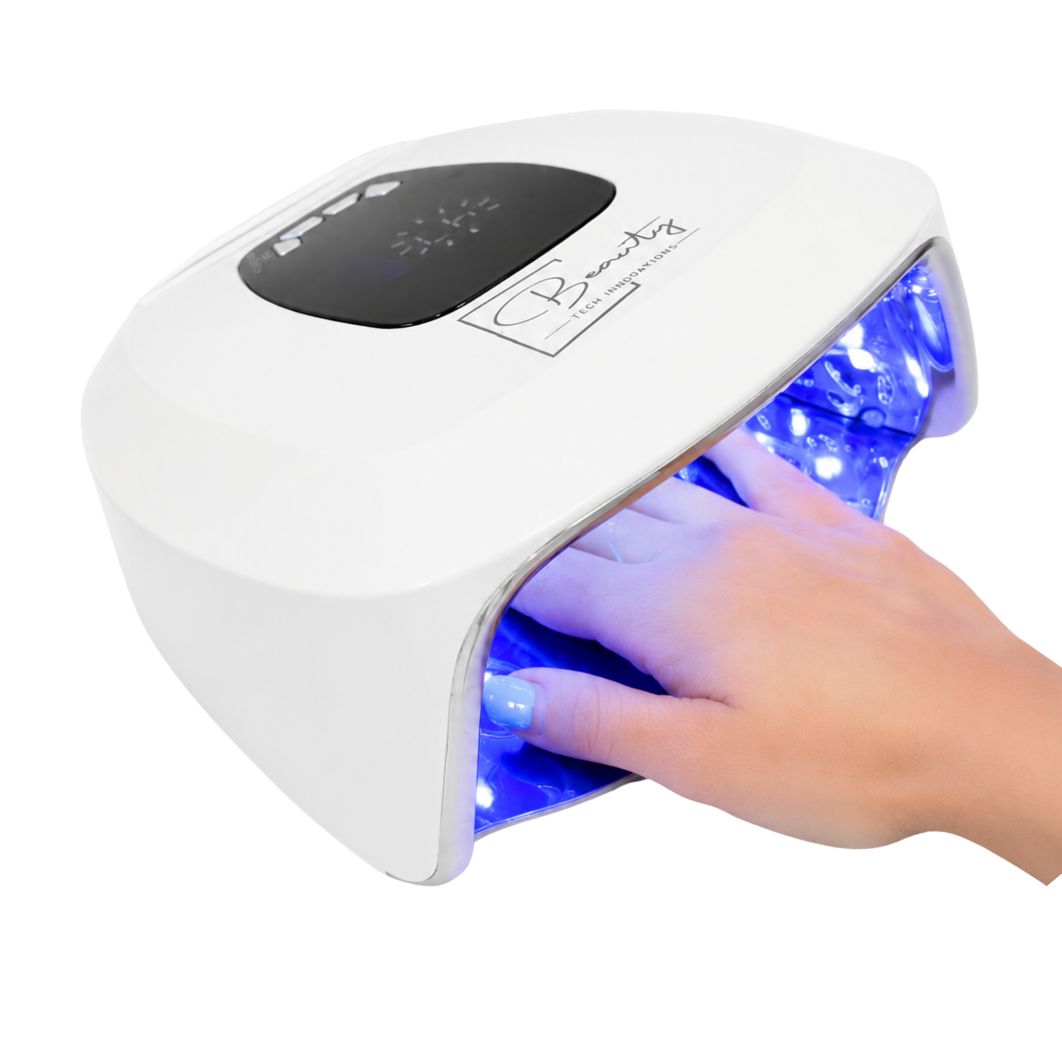Hand inside AuraLux cordless LED nail lamp demonstrating professional gel nail curing